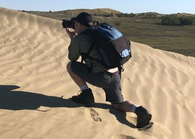 Dave taking a photo in the Sand Hills